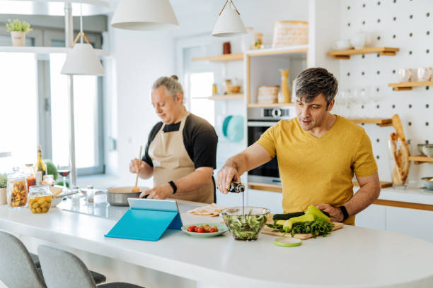 Mature gay couple cooking together